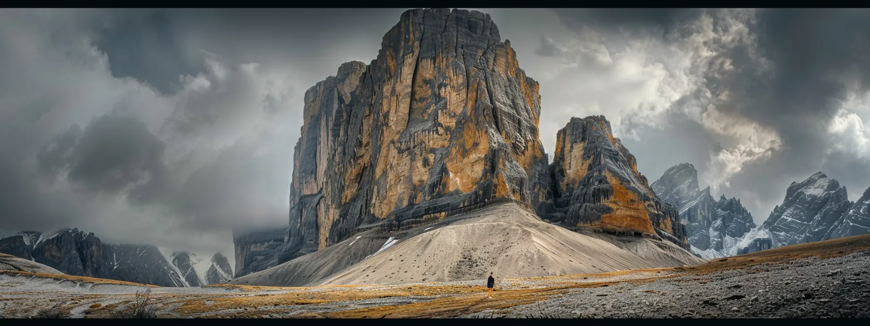 a solitary figure standing at the base of a towering mountain, symbolizing the journey from dream to achievable goal.